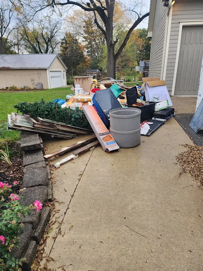 Dumpster being loaded with debris for Roofing Dumpster Rental in Ardsley
